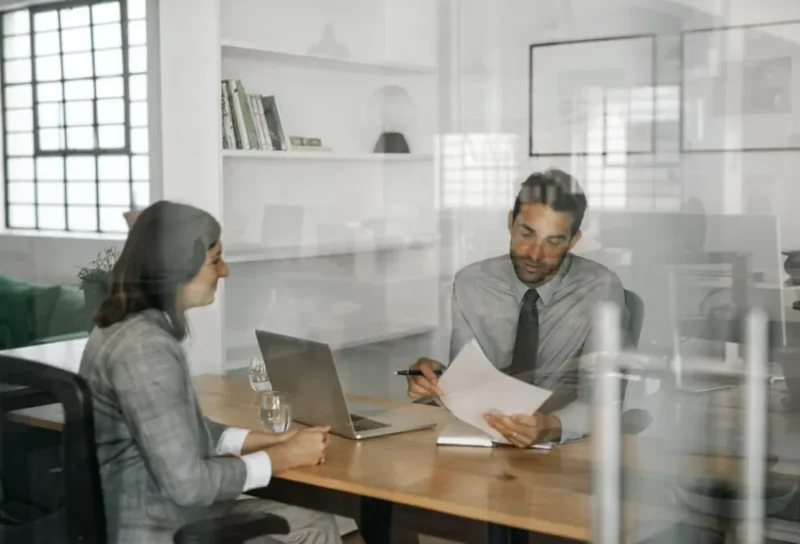 People reviewing documents together at a table.